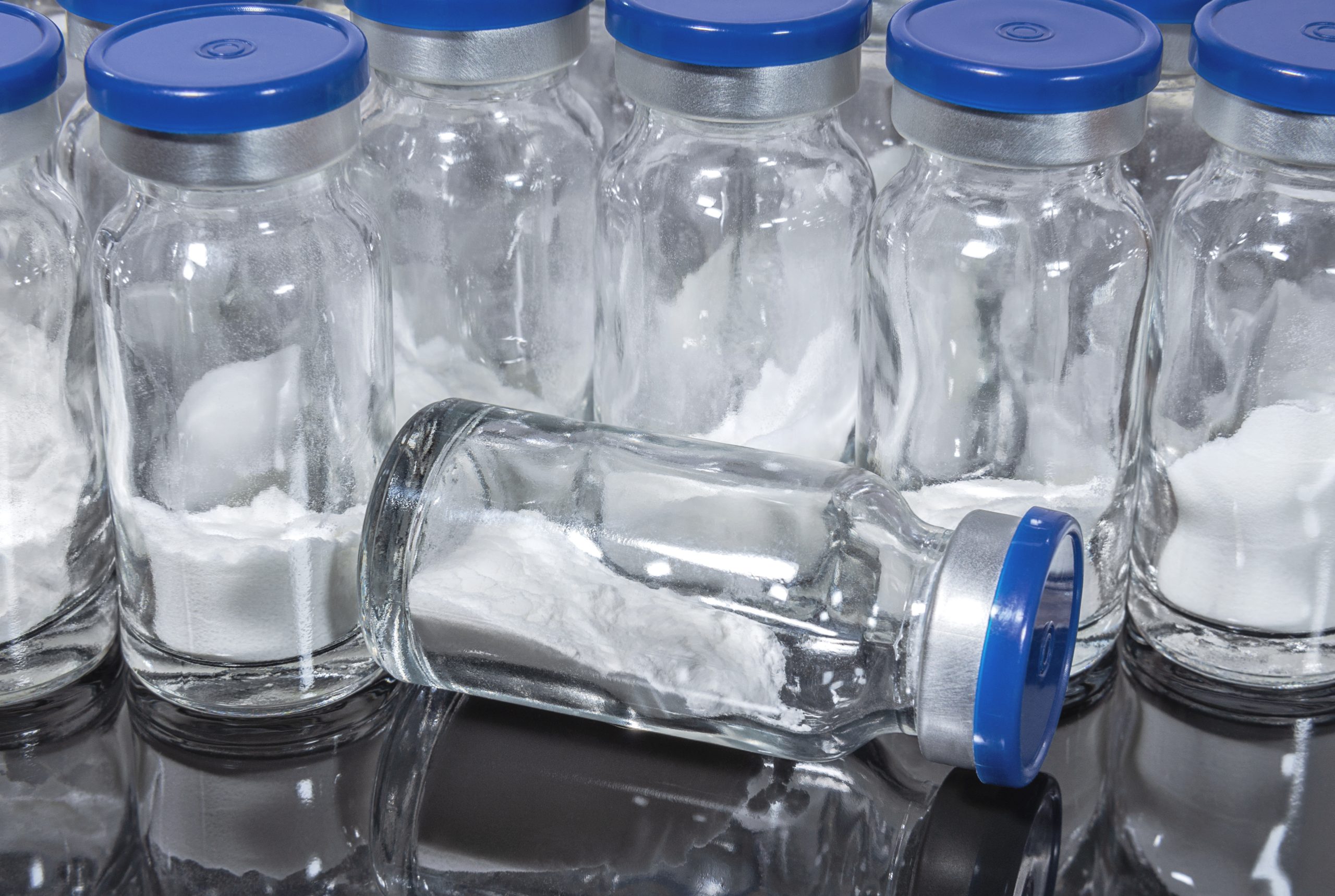 Medical vials with white powder vaccine